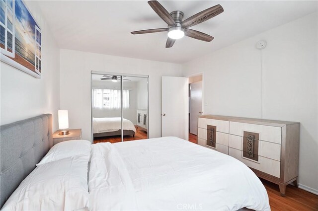 bedroom featuring ceiling fan, wood-type flooring, and a closet