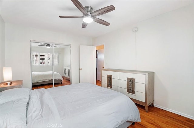 bedroom with hardwood / wood-style floors, a closet, and ceiling fan