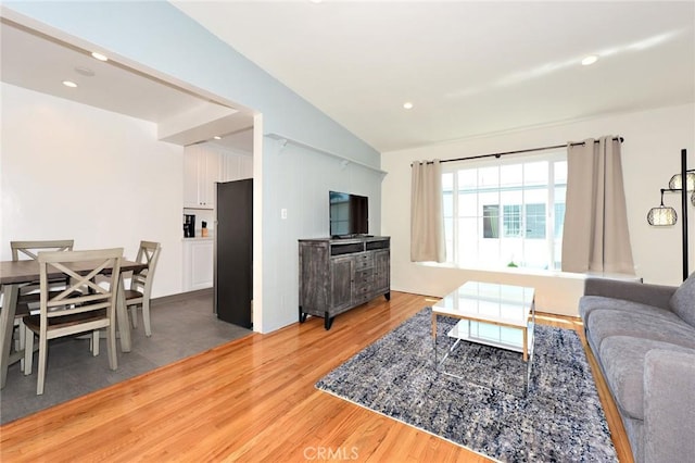 living room featuring hardwood / wood-style floors and lofted ceiling