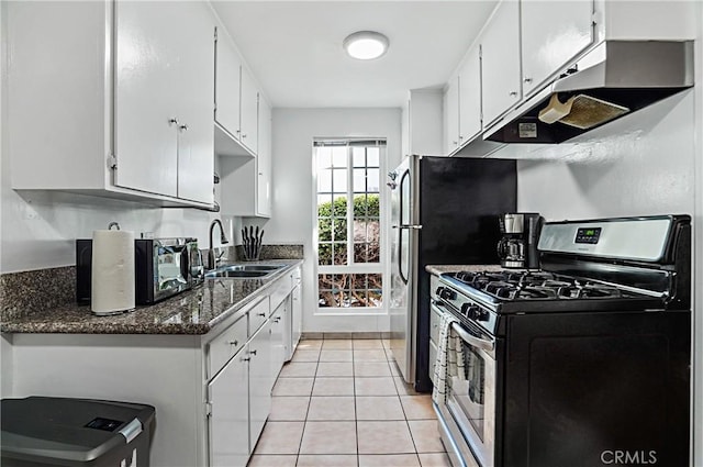 kitchen featuring gas range, sink, white cabinetry, and light tile patterned flooring