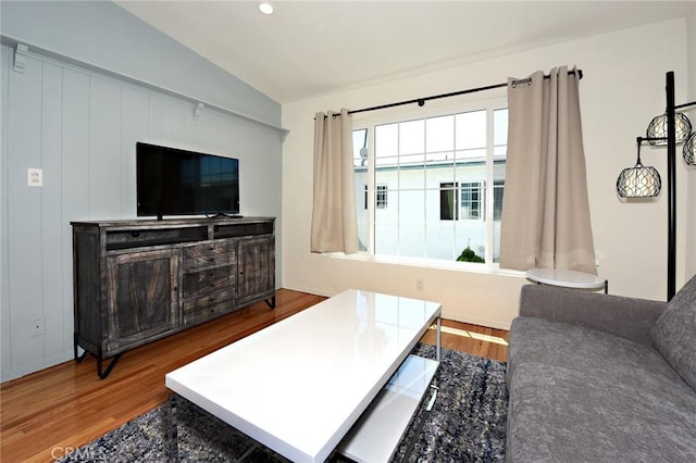 living room featuring wood-type flooring and lofted ceiling