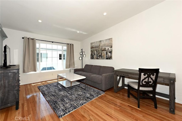 living room featuring hardwood / wood-style floors and lofted ceiling