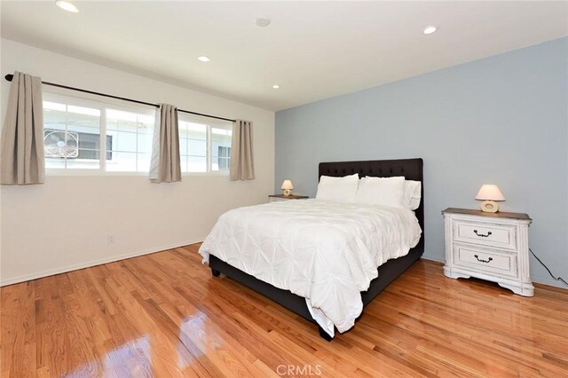 bedroom featuring light hardwood / wood-style floors and multiple windows