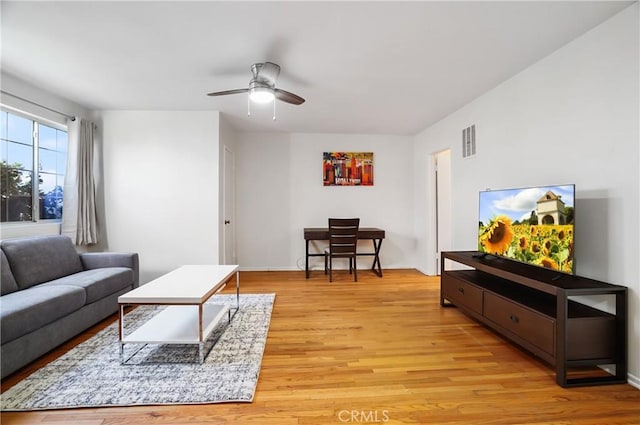 living room featuring light wood-type flooring and ceiling fan