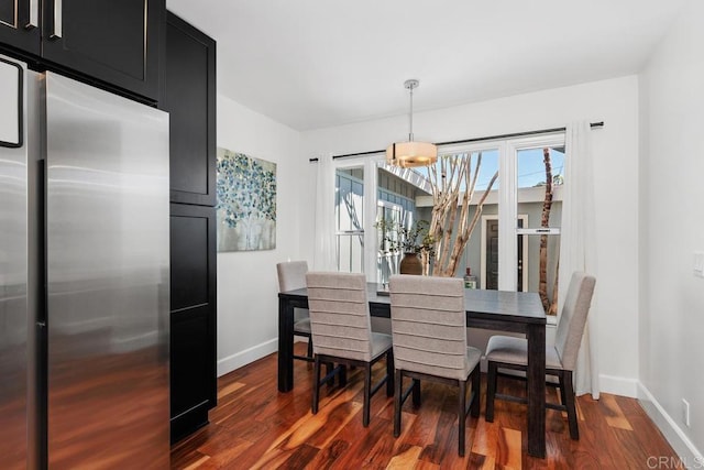 dining area featuring dark wood-type flooring