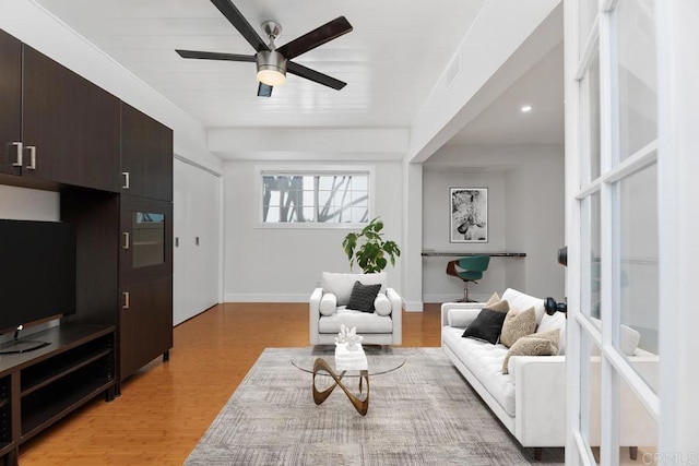 living room with ceiling fan, light hardwood / wood-style flooring, and wooden ceiling