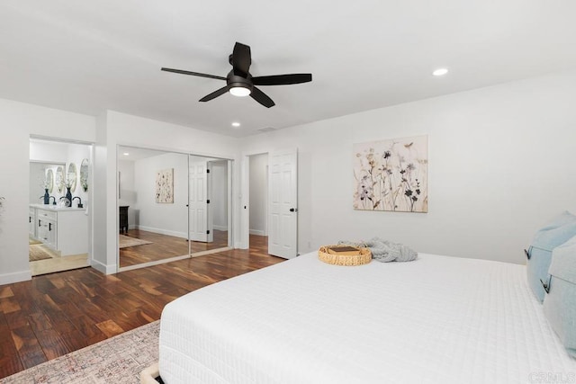 bedroom with ceiling fan, dark hardwood / wood-style flooring, and a closet