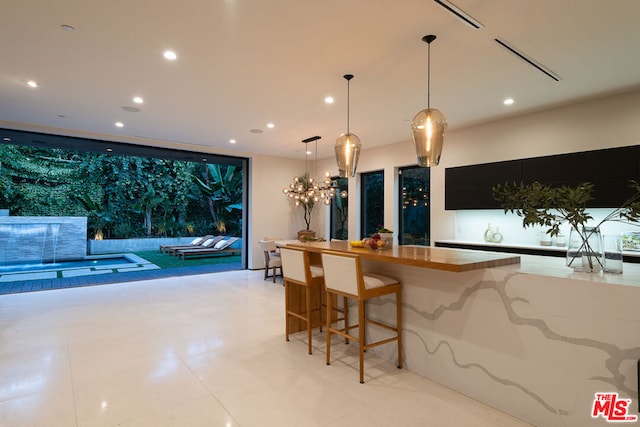 kitchen with a kitchen bar and pendant lighting