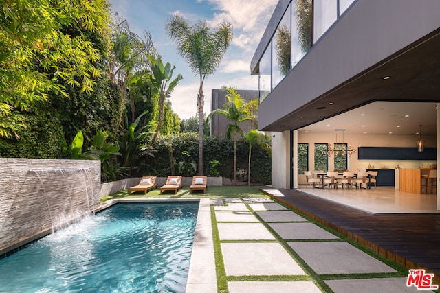 view of pool with pool water feature and a patio