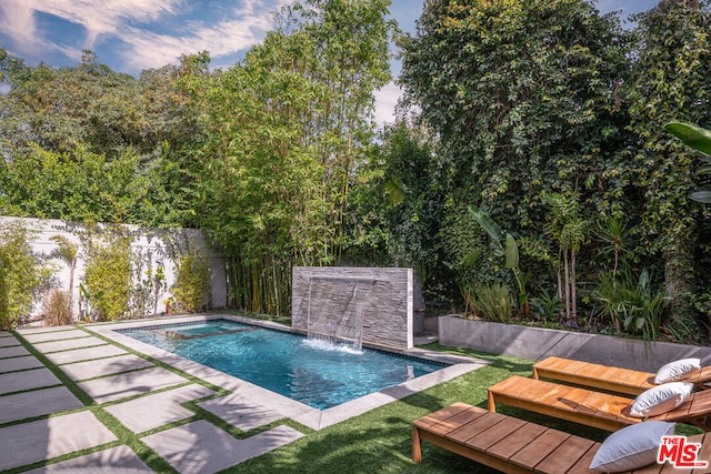 view of swimming pool featuring a patio area and pool water feature