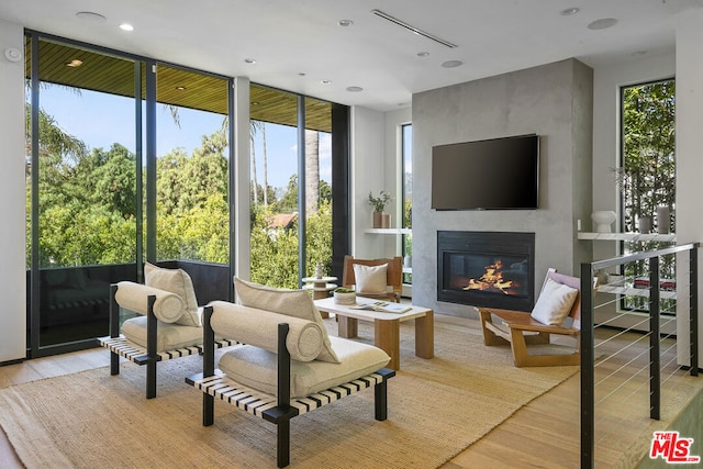 sunroom / solarium featuring a healthy amount of sunlight and a fireplace