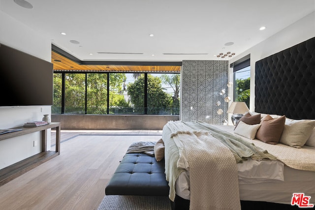 bedroom featuring hardwood / wood-style floors and multiple windows