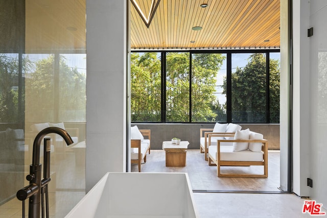 sunroom featuring plenty of natural light and sink