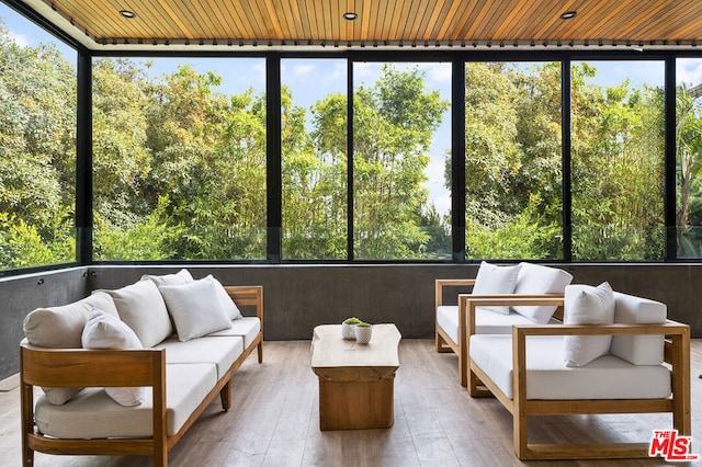 unfurnished sunroom featuring a healthy amount of sunlight and wood ceiling