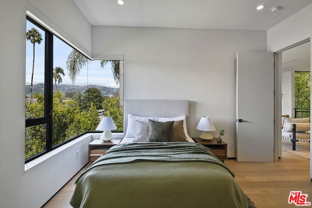 bedroom featuring light wood-type flooring and multiple windows