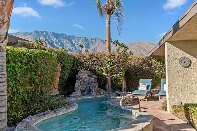 view of pool with a patio area and a mountain view