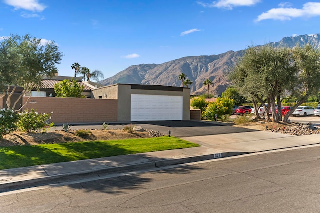 view of front of property featuring a mountain view and a garage