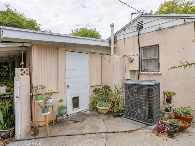 doorway to property featuring central air condition unit