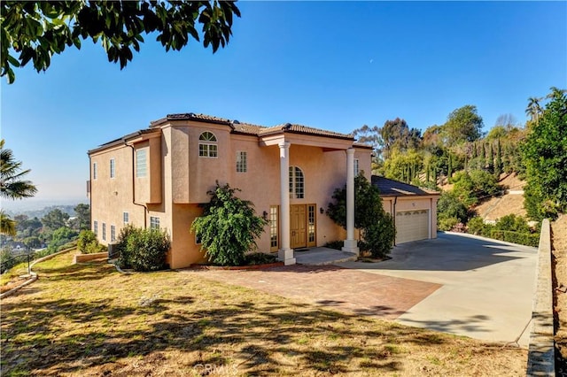 view of front of property featuring a garage and a front lawn