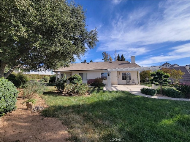 back of property with a pergola, a yard, and a patio