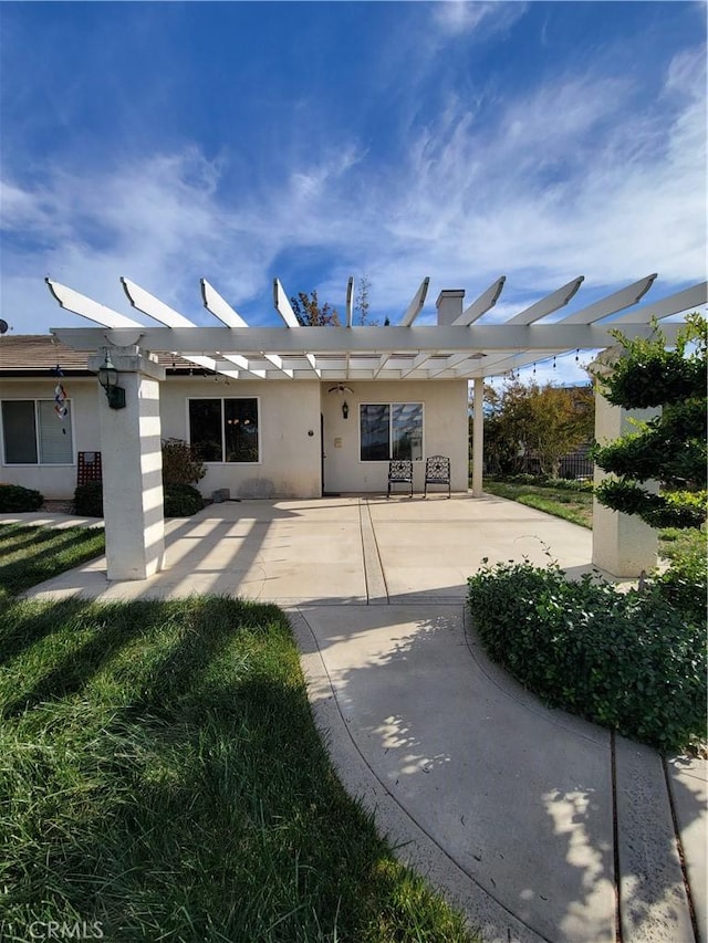 back of property with a pergola