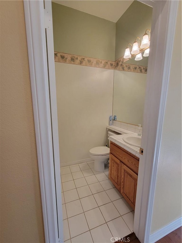 bathroom featuring tile patterned floors, vanity, and toilet