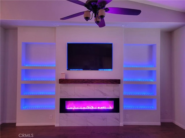 unfurnished living room with ceiling fan, built in features, wood-type flooring, and lofted ceiling