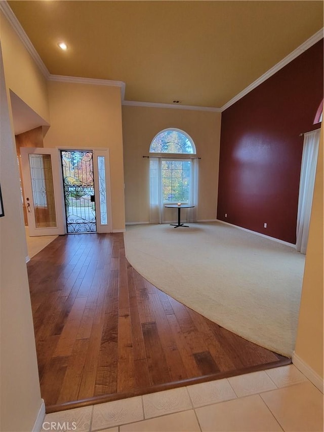 entryway featuring hardwood / wood-style floors and ornamental molding