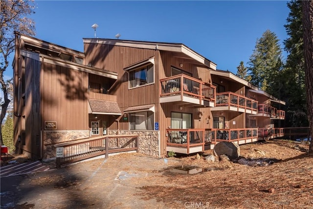 7540 Henness Cir Unit B101, Yosemite, CA 95389 - rear view of house featuring stone siding and a balcony
