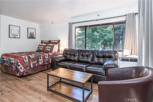 7540 Henness Cir Unit B101, Yosemite, CA 95389 - bedroom with wood finished floors and a wall mounted AC