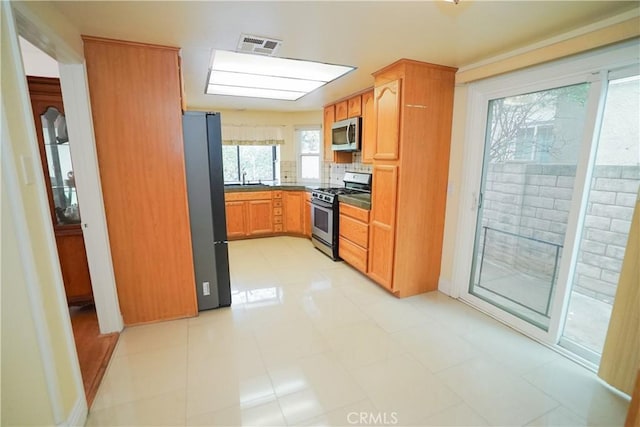 kitchen featuring sink, light tile patterned floors, and stainless steel appliances