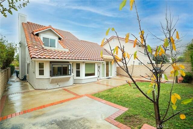 back of property with a patio