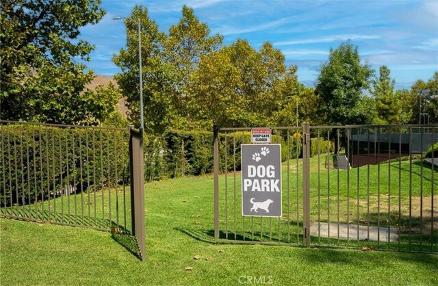 view of gate featuring a yard