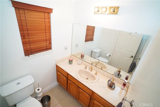 bathroom featuring tile patterned flooring, vanity, and toilet