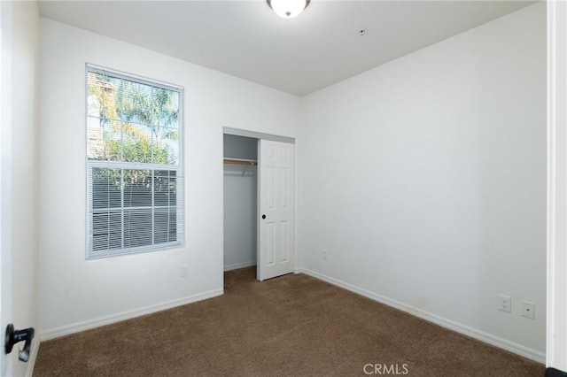 unfurnished bedroom featuring a closet and carpet floors