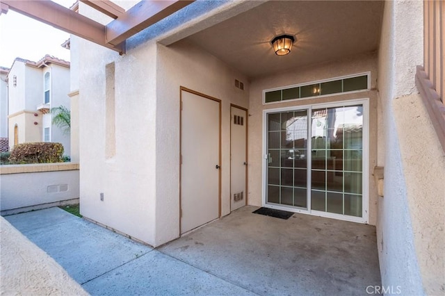 entrance to property featuring a patio