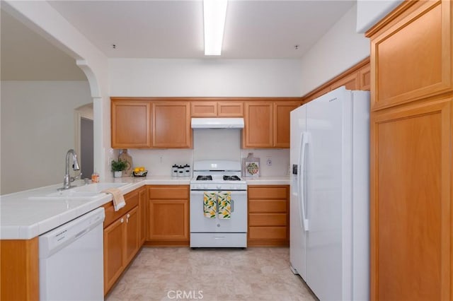 kitchen featuring kitchen peninsula, white appliances, and sink