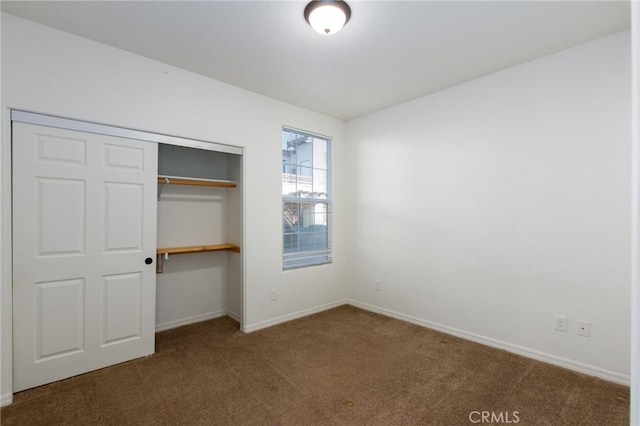 unfurnished bedroom with carpet floors and a closet