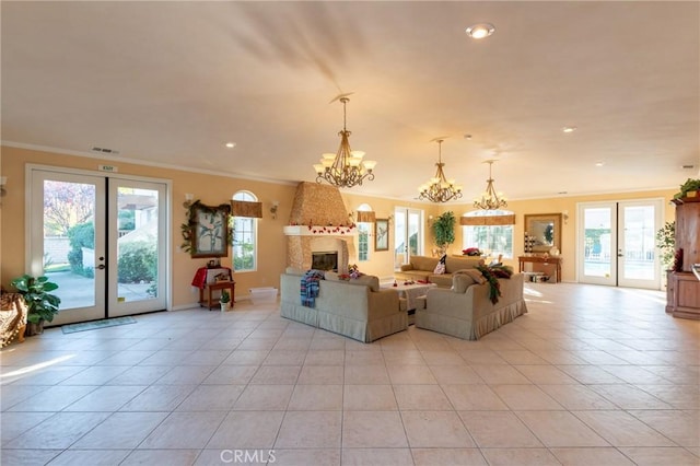 unfurnished living room with crown molding, french doors, light tile patterned floors, and a notable chandelier