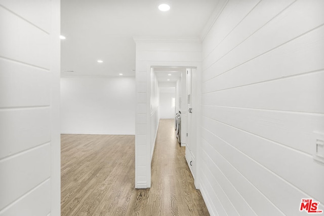 hall featuring hardwood / wood-style floors and ornamental molding