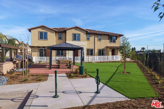 view of front of home with a gazebo and a front yard