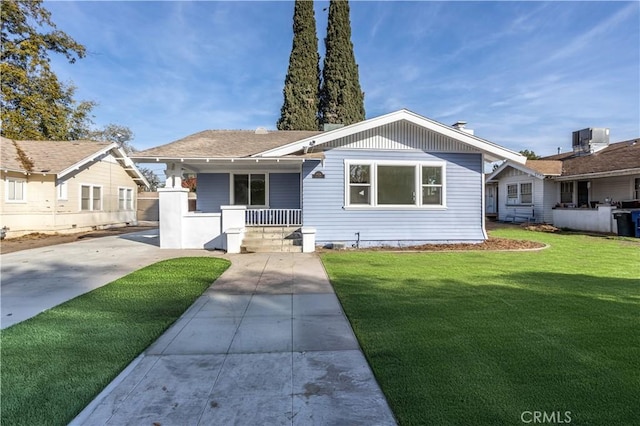 view of front of home with a porch and a front yard