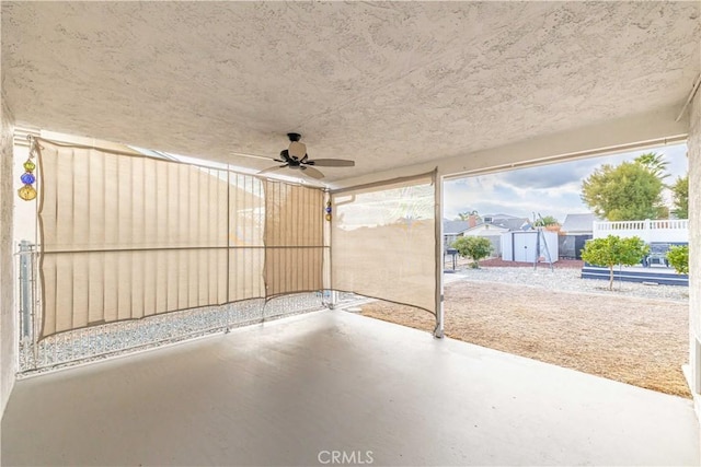 view of patio / terrace featuring ceiling fan and a storage shed