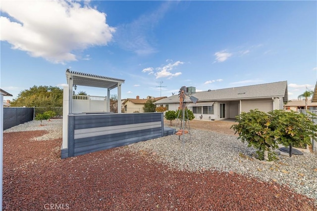 back of property featuring a pergola