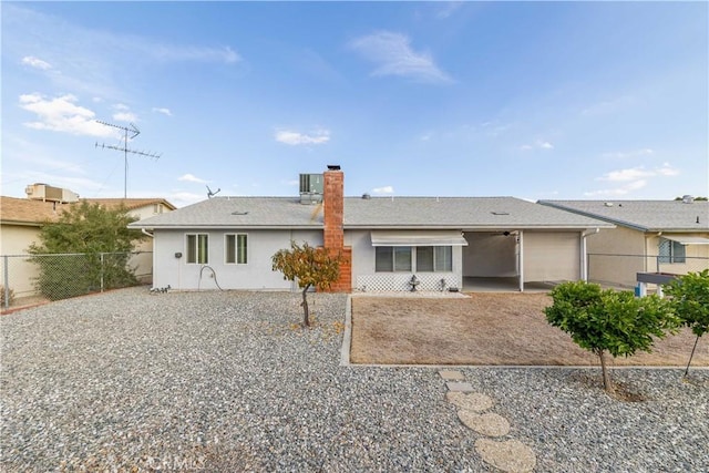 rear view of property featuring a patio area and central AC