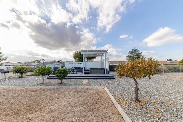 view of home's community featuring a jacuzzi and a deck