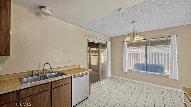 kitchen with an inviting chandelier, light tile patterned floors, decorative light fixtures, dishwasher, and sink