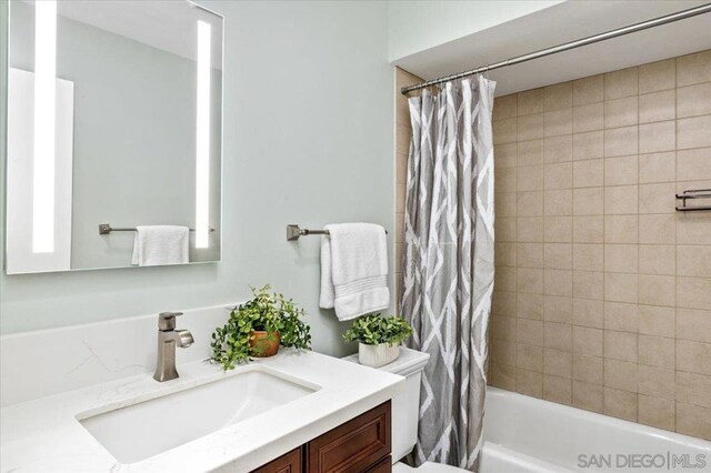 full bathroom with vanity, toilet, and shower / bath combo with shower curtain