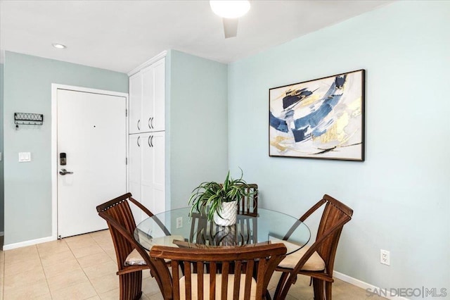 tiled dining area with ceiling fan