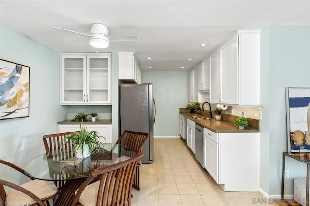 kitchen with white cabinetry, sink, ceiling fan, stainless steel appliances, and light tile patterned floors